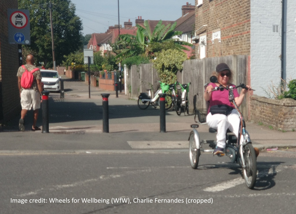 A tricycle user emerging from a traffic fllter.