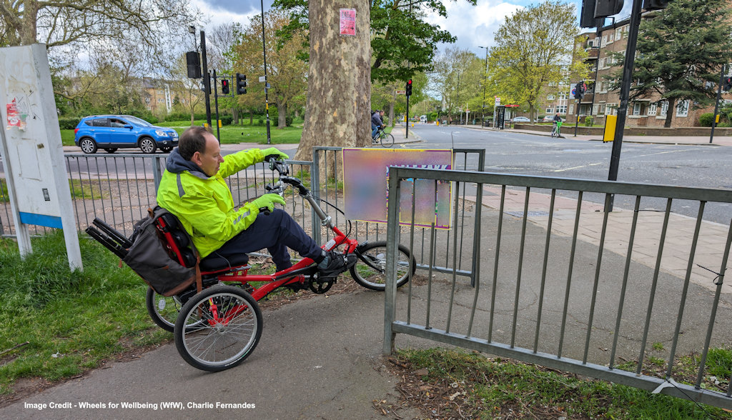 Tricycle user attempting to navigate through narrow barriers.